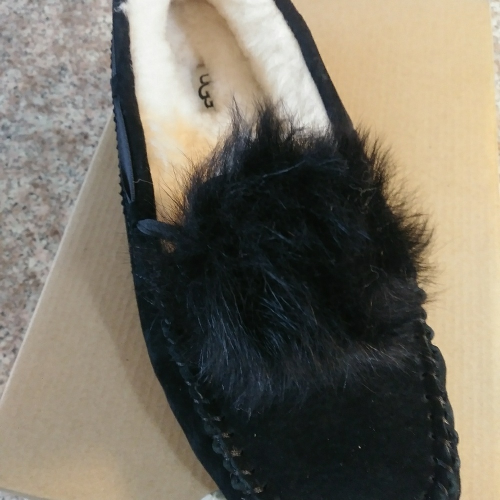 Black pom pom style Ugg slip-ons
